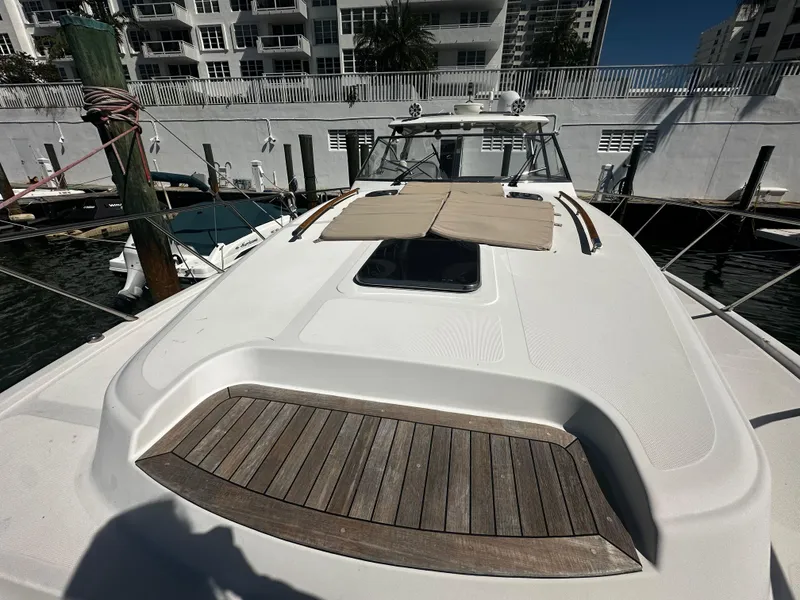 Slide: The Image of 2006 Chris-Craft 43 Roamer yacht docked, featuring sleek design and spacious deck. - 47
