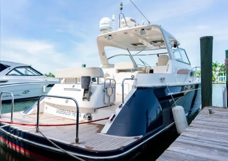 Slide: The Image of 2006 Chris-Craft 43 Roamer yacht docked, showcasing sleek design and luxury features. - 48