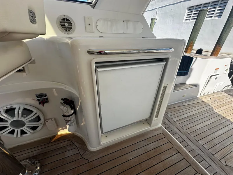 Slide: The Image of 2006 Chris-Craft 43 Roamer yacht interior with wooden deck and built-in storage. - 7