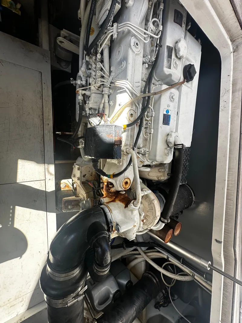 Slide: The Image of Engine compartment of a 2006 Chris-Craft 43 Roamer boat, showcasing mechanical components. - 15