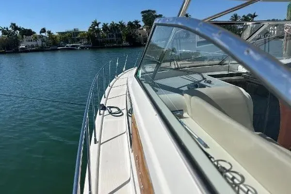 Slide: The Image of 2006 Chris-Craft Roamer 40 yacht on calm water, showcasing sleek design and luxurious seating. - 30