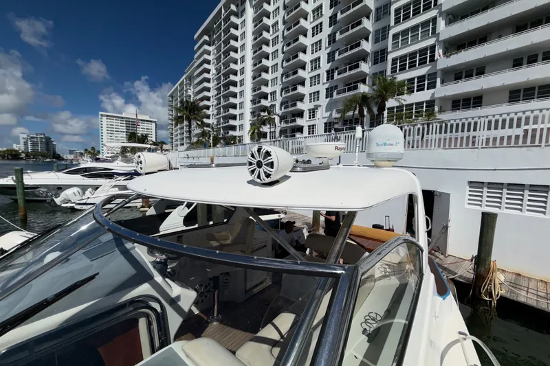 Slide: The Image of 2006 Chris-Craft Roamer 40 yacht docked near modern waterfront buildings. - 31