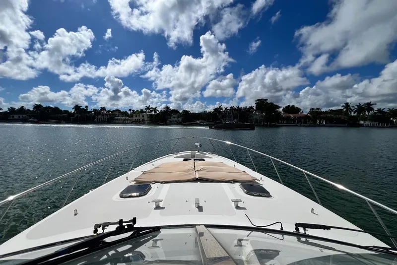 Slide: The Image of 2006 Chris-Craft Roamer 40 yacht cruising on a sunny day with scenic waterfront view. - 29