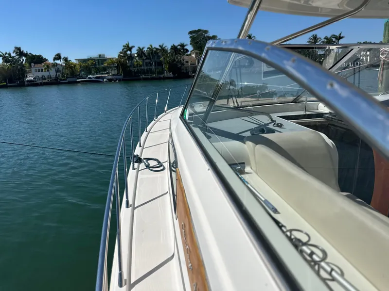 Slide: The Image of 2006 Chris-Craft 43 Roamer yacht on calm water, showcasing sleek design and luxurious seating. - 43