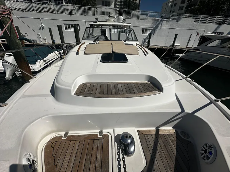 Slide: The Image of 2006 Chris-Craft 43 Roamer yacht with wooden deck, docked at marina. - 45