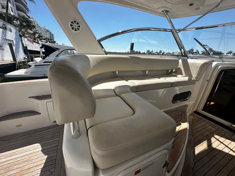 Slide: The Image of 2006 Chris-Craft 43 Roamer yacht interior with beige seating and wooden flooring. - 9