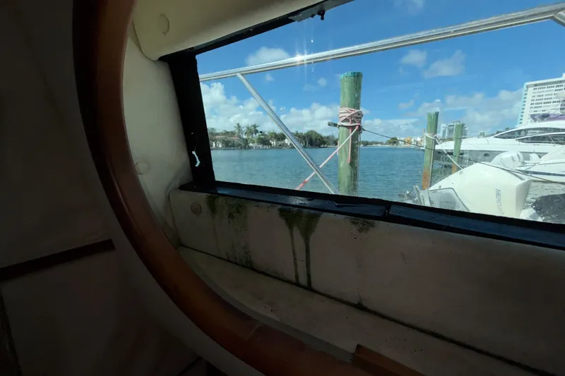 Slide: The Image of View from a 2006 Chris-Craft Roamer 40 window, overlooking a marina with boats and clear skies. - 34