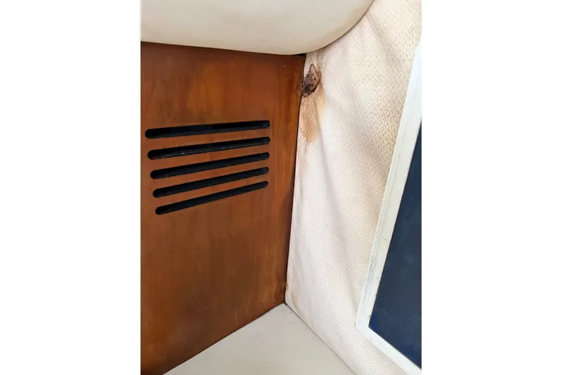 Slide: The Image of Interior detail of 2006 Chris-Craft Roamer 40, featuring wood paneling and fabric wall. - 40