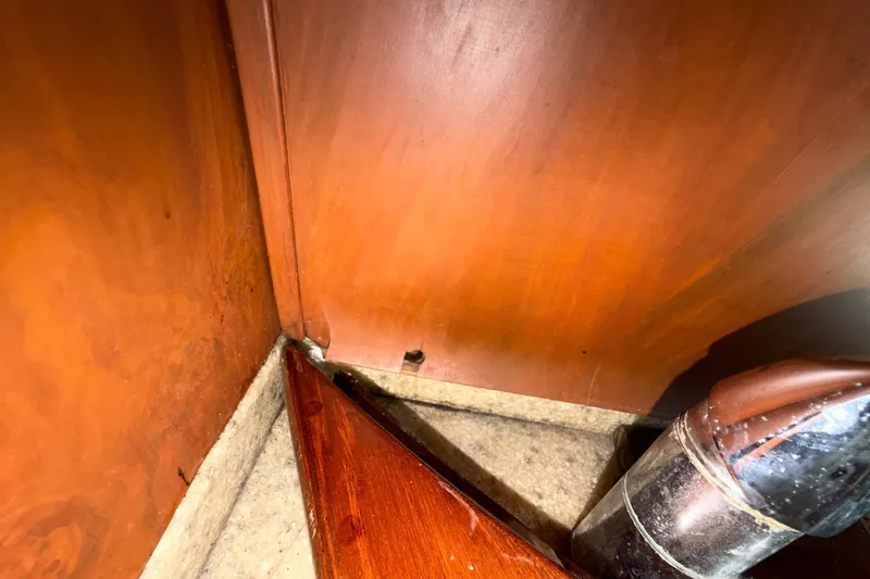 Slide: The Image of Interior corner of 2006 Chris-Craft Roamer 40 boat, featuring wood paneling and metal pipe. - 46