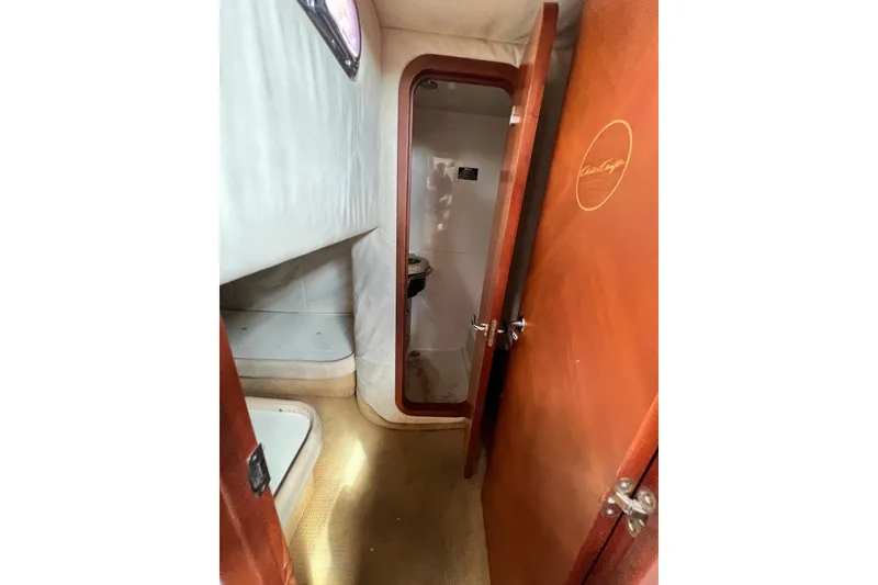 Slide: The Image of Interior cabin view of 2006 Chris-Craft Roamer 40 yacht, featuring wooden door and cozy layout. - 23