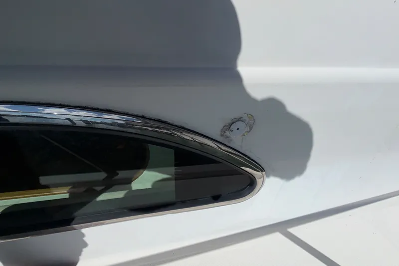 Slide: The Image of Close-up of 2006 Chris-Craft Roamer 40 boat exterior with window and surface damage. - 41