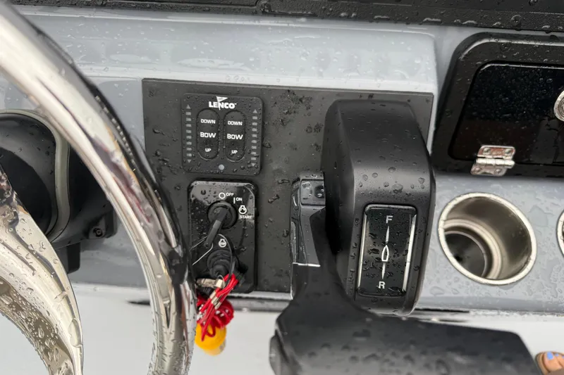 Slide: The Image of 2026 Blazer Bay 2220 Fisherman boat controls with steering wheel and switches. - 11