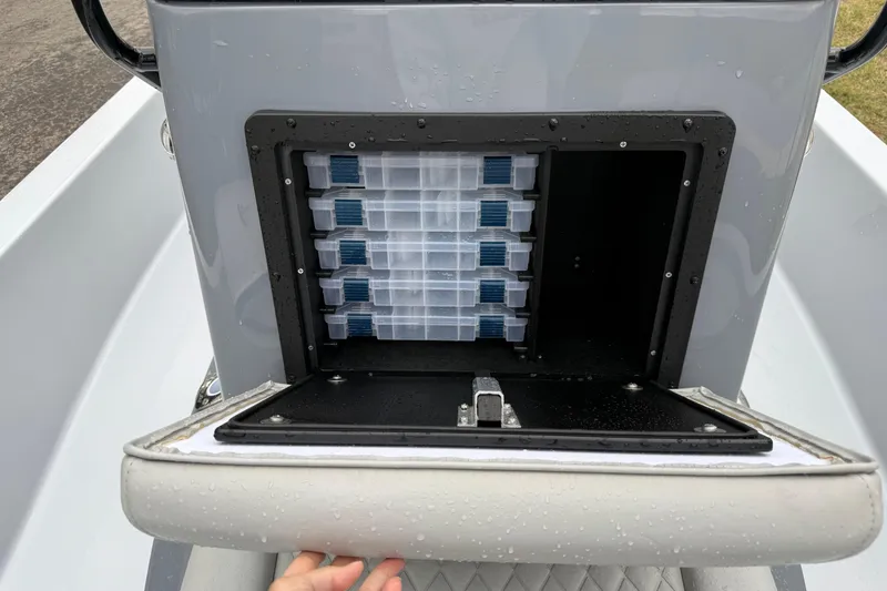 Slide: The Image of 2026 Blazer Bay 2220 Fisherman boat storage compartment with tackle boxes. - 16