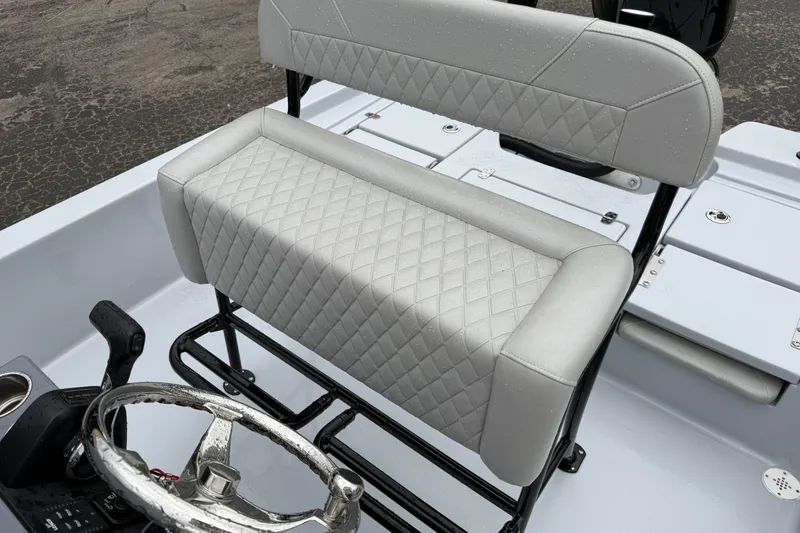 Slide: The Image of 2026 Blazer Bay 2220 Fisherman boat seat with diamond-stitched upholstery and steering wheel. - 18
