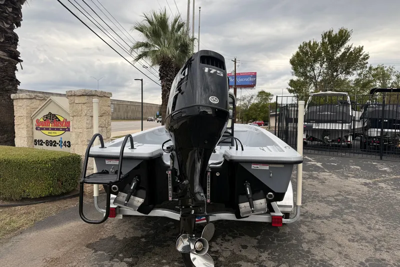 Slide: The Image of 2026 Blazer Bay 2220 Fisherman boat with powerful outboard motor in dealership lot. - 2