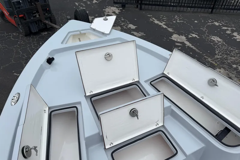 Slide: The Image of 2026 Blazer Bay 2220 Fisherman boat with open storage compartments on deck. - 25