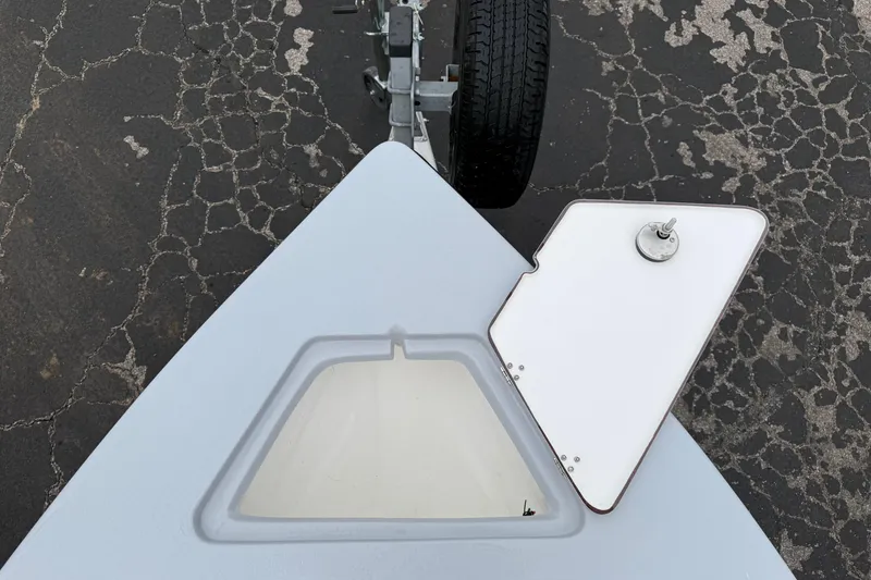 Slide: The Image of 2026 Blazer Bay 2220 Fisherman boat bow with open hatch on trailer. - 26