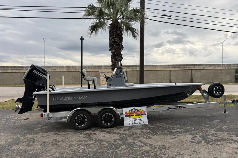 Slide: The Image of 2026 Blazer Bay 2220 Fisherman boat on trailer, parked outdoors. - 33