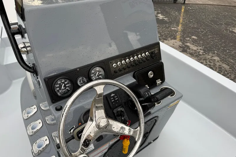 Slide: The Image of 2026 Blazer Bay 2220 Fisherman boat dashboard with steering wheel and controls. - 8