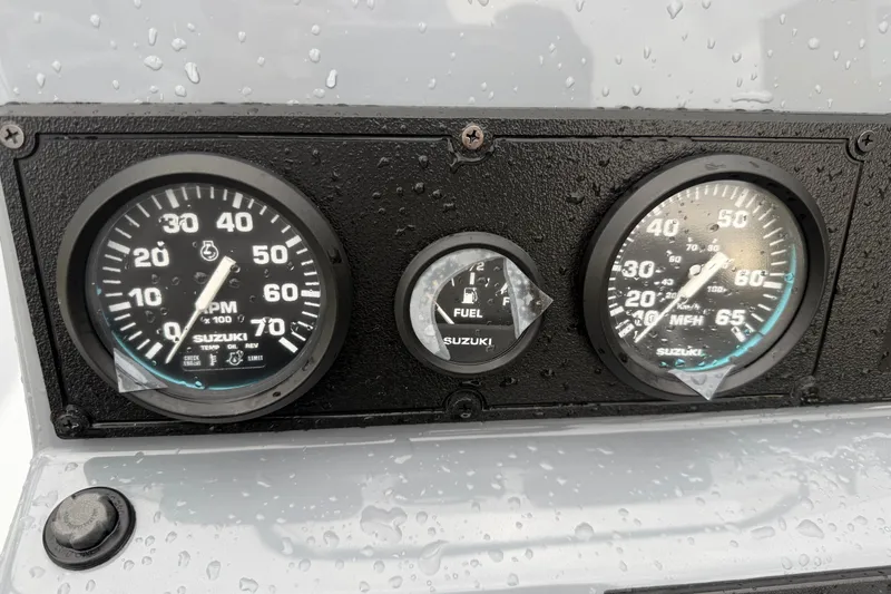 Slide: The Image of Dashboard of 2026 Blazer Bay 2220 Fisherman with Suzuki gauges in rainy conditions. - 9