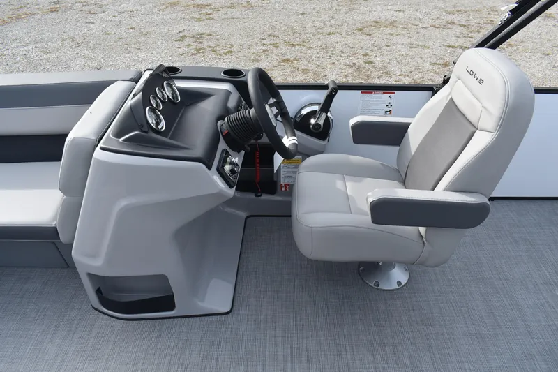 Slide: The Image of Captain's seat and helm of 2026 Lowe LS 210 WT boat, featuring modern controls. - 11