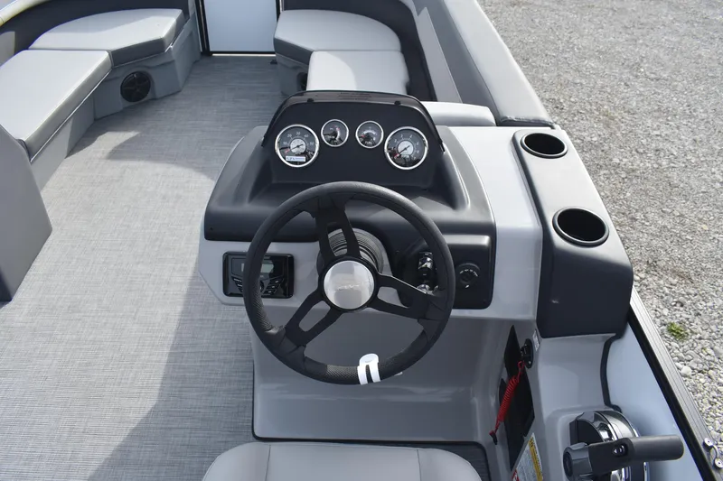 Slide: The Image of 2026 Lowe LS 210 WT boat interior with steering wheel and dashboard controls. - 12