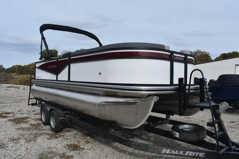 Slide: The Image of 2026 Lowe LS 210 WT pontoon boat on trailer, parked outdoors. - 5