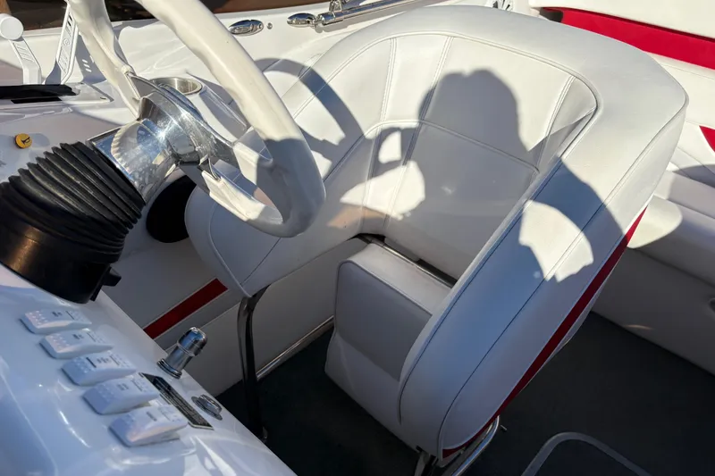 Slide: The Image of 2007 Nordic Boats 28 Heat cockpit with white leather seat and steering wheel. - 11