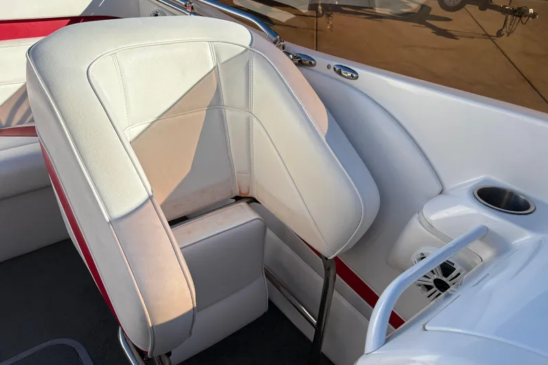 Slide: The Image of 2007 Nordic Boats 28 Heat interior with white and red seating, cup holder, and speaker. - 12