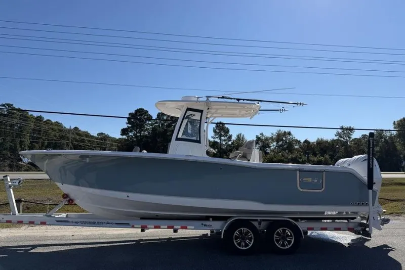 Slide: The Image of 2025 Sea Hunt Gamefish 27 Forward Seating boat on trailer, side view. - 0