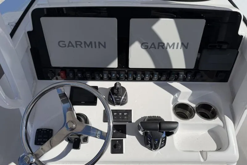 Slide: The Image of 2025 Sea Hunt Gamefish 27 Forward Seating boat on trailer, parked outdoors. - 1