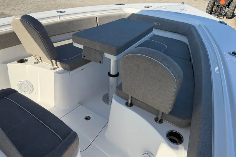 Slide: The Image of 2025 Sea Hunt Gamefish 27 Forward Seating with gray cushioned seats and table. - 10