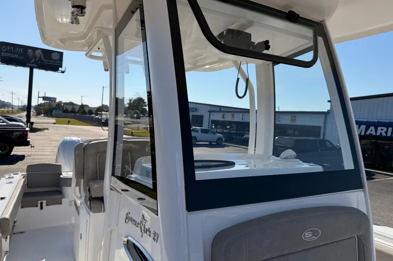 Slide: The Image of 2025 Sea Hunt Gamefish 27 boat with forward seating, docked outdoors. - 12
