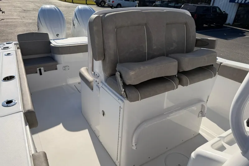 Slide: The Image of 2025 Sea Hunt Gamefish 27 Forward Seating boat interior with cushioned seats and dual engines. - 13