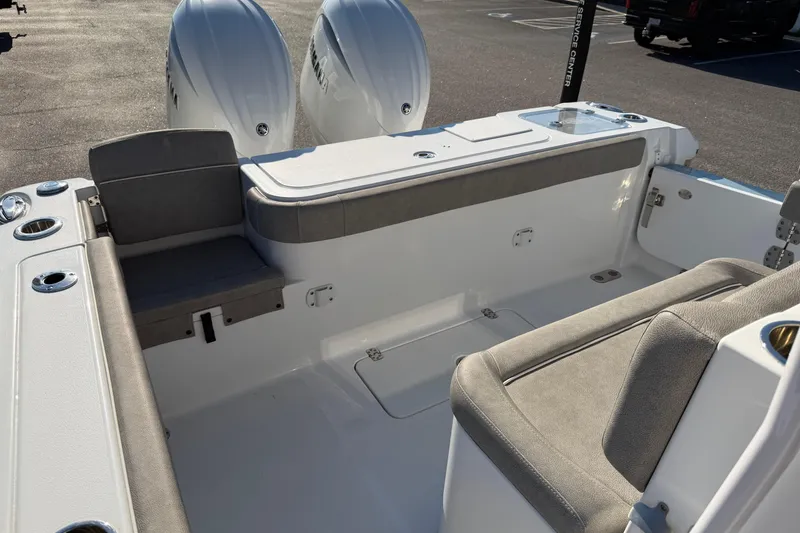 Slide: The Image of 2025 Sea Hunt Gamefish 27 Forward Seating boat interior with dual engines and cushioned seating. - 16