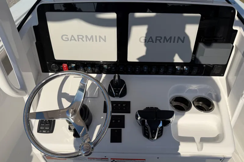Slide: The Image of 2025 Sea Hunt Gamefish 27 dashboard with Garmin displays and steering wheel. - 19