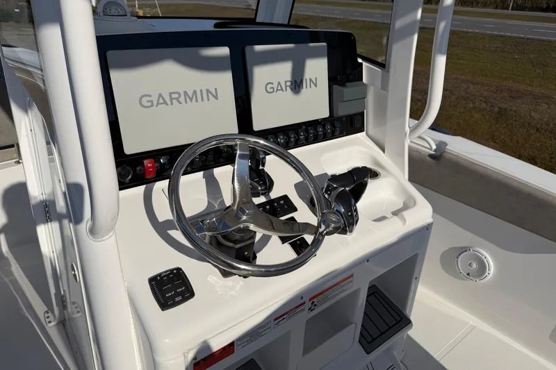 Slide: The Image of 2025 Sea Hunt Gamefish 27 helm with dual Garmin displays and steering wheel. - 20