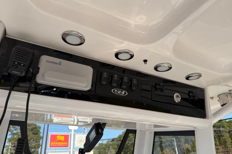 Slide: The Image of 2025 Sea Hunt Gamefish 27 dashboard with Garmin electronics and control panel. - 21