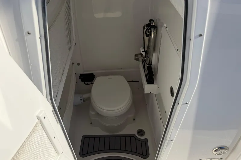 Slide: The Image of 2025 Sea Hunt Gamefish 27 Forward Seating boat interior with compact marine toilet. - 22