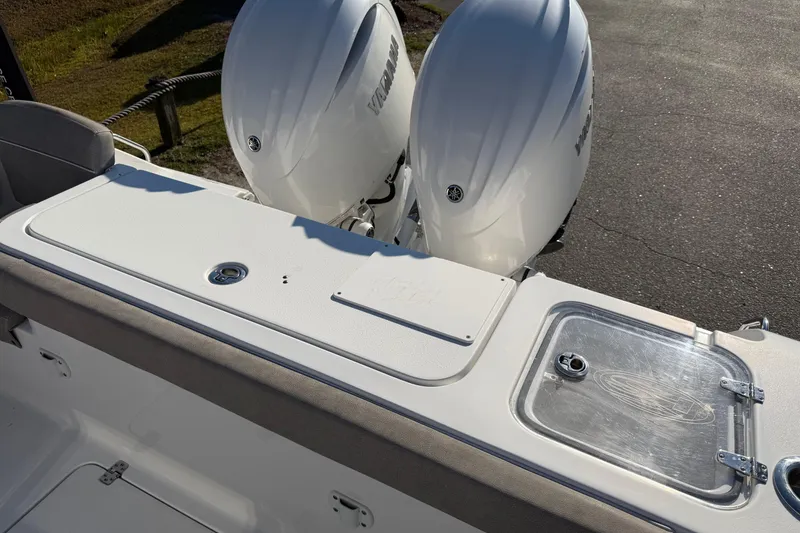 Slide: The Image of 2025 Sea Hunt Gamefish 27 boat with dual Yamaha engines, featuring forward seating. - 25