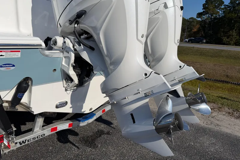 Slide: The Image of 2025 Sea Hunt Gamefish 27 boat with dual outboard motors on a trailer. - 27