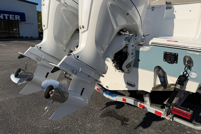 Slide: The Image of 2025 Sea Hunt Gamefish 27 boat with dual outboard motors on a trailer. - 28