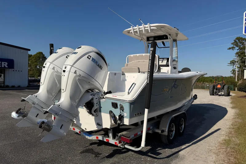 Slide: The Image of 2025 Sea Hunt Gamefish 27 Forward Seating boat with dual engines on a trailer. - 5