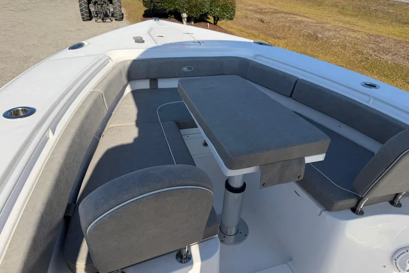 Slide: The Image of 2025 Sea Hunt Gamefish 27 Forward Seating with cushioned seating and table. - 9