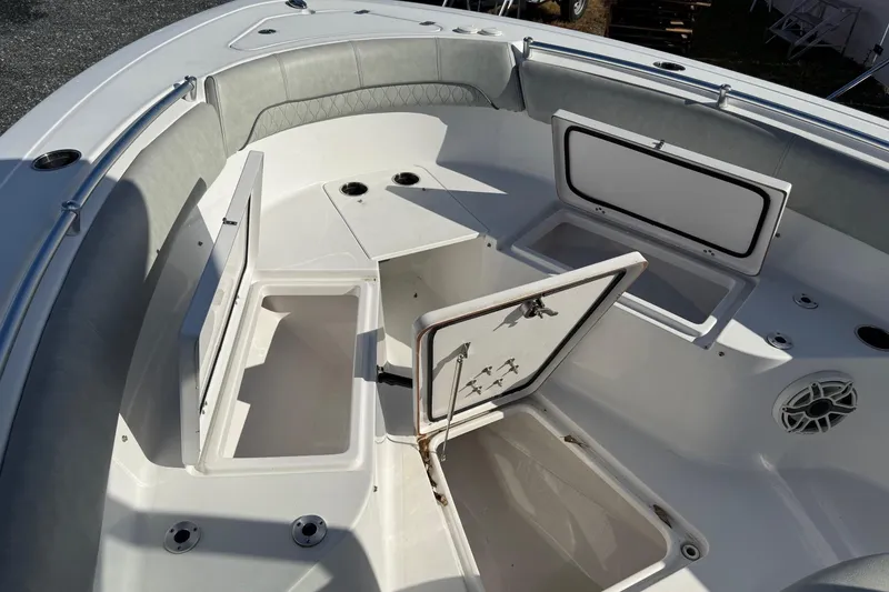 Slide: The Image of 2021 Sportsman Heritage 251 Center Console boat interior with open storage compartments. - 10