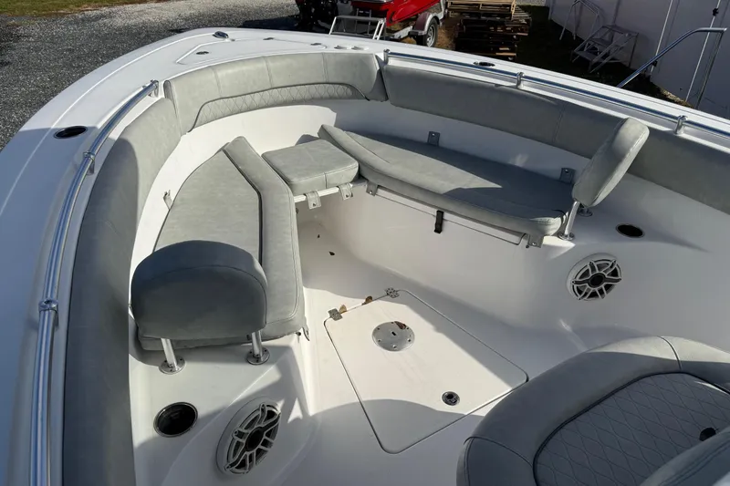 Slide: The Image of 2021 Sportsman Heritage 251 Center Console boat interior with gray seating and speakers. - 12