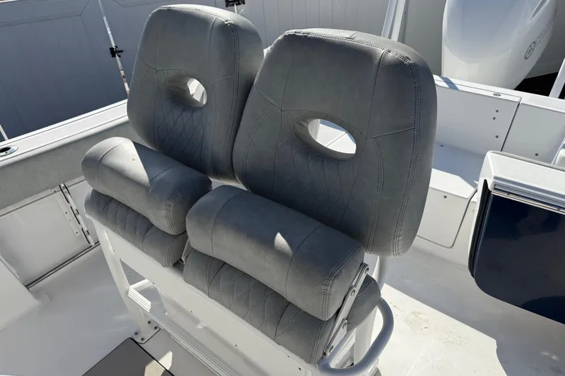 Slide: The Image of 2021 Sportsman Heritage 251 Center Console boat seating, featuring cushioned dual seats. - 5