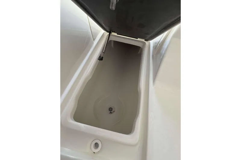 Slide: The Image of Storage compartment of 2026 Key West 239 DFS boat, open lid view. - 16