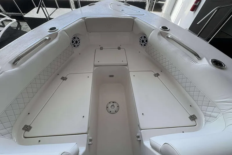 Slide: The Image of 2026 Key West 239 DFS boat interior with white seating and storage compartments. - 22