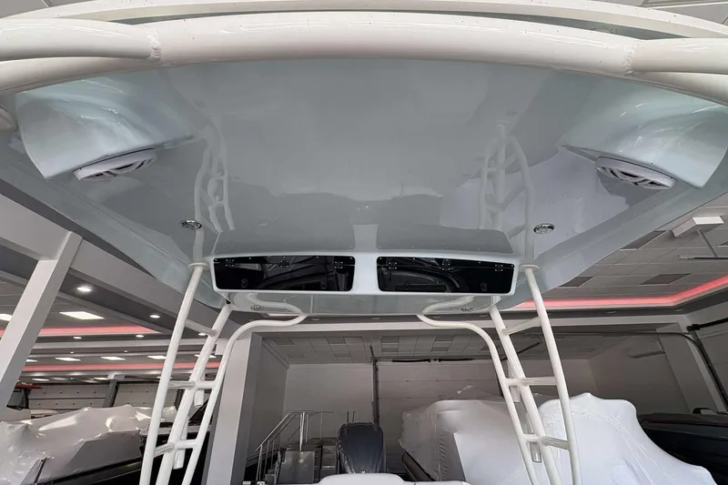 Slide: The Image of 2026 Key West 239 DFS boat interior with speakers and ladder in showroom. - 9